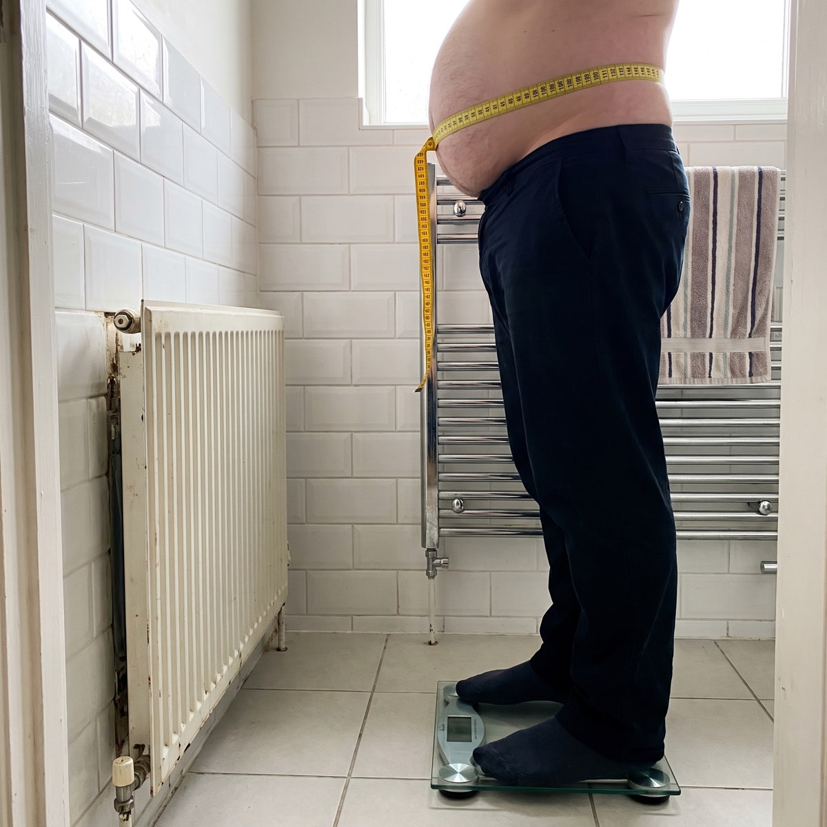 Tape measure round a hard, round belly